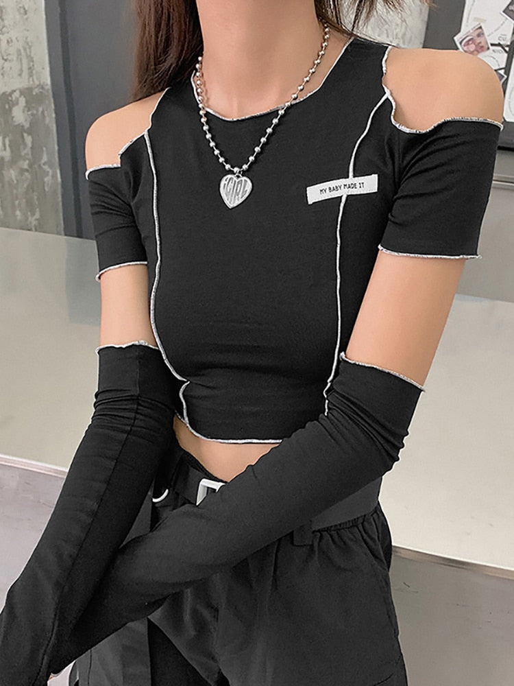 "Black Gothic crop top featuring intricate patchwork design and stylish open shoulders."