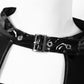 Black patent leather crop top featuring punk-inspired buckle details