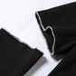 "Make a fashion statement with this Gothic crop top, adorned with unique patchwork and flattering open shoulders."