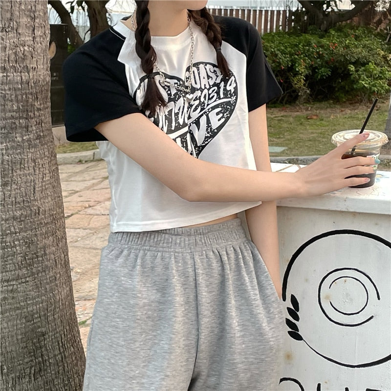 Black crop top t-shirt with grunge-inspired graphic print